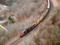 For me it is hard to believe that it is coming up to four years already since the acquisition by CN of those first batch x-UP (CNW) locomotives, the C40-8s. There were 42 of them, numbered 9023-9064, and were to become CN 2000-2041. I had received a message there were some on the #396 that day, and it was a mad rush to Dundas from Grimsby, as I had planned to scurry up the hill in order to get a decent shot of all the power. In retrospect, it was a good thing I had been up to Dundas Peak a few times that fall. Being in shape enabled me to get to where I wanted to be with about 5 minutes to spare. (Not doing this any more though, my shape has changed) On 396 behind leader CN 2500 is 2589, with CREX 9060, 9041, 9032 and 9058. They currently operate on CN as 2037, 2018, 2009 and 2035 respectively. After these units were retired by UP in 2008/2009, Citicorp Railmark took possession of them, hence the CREX on the cabs. Note this image was taken the day before Christmas. No snow anywhere. Heck, it wasn't even cold...........