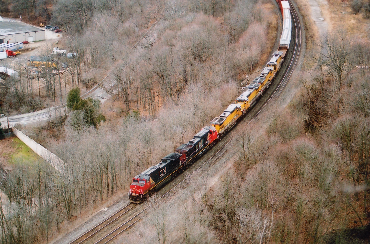 For me it is hard to believe that it is coming up to four years already since the acquisition by CN of those first batch x-UP (CNW) locomotives, the C40-8s. There were 42 of them, numbered 9023-9064, and were to become CN 2000-2041. I had received a message there were some on the #396 that day, and it was a mad rush to Dundas from Grimsby, as I had planned to scurry up the hill in order to get a decent shot of all the power. In retrospect, it was a good thing I had been up to Dundas Peak a few times that fall. Being in shape enabled me to get to where I wanted to be with about 5 minutes to spare. (Not doing this any more though, my shape has changed) On 396 behind leader CN 2500 is 2589, with CREX 9060, 9041, 9032 and 9058. They currently operate on CN as 2037, 2018, 2009 and 2035 respectively. After these units were retired by UP in 2008/2009, Citicorp Railmark took possession of them, hence the CREX on the cabs. Note this image was taken the day before Christmas. No snow anywhere. Heck, it wasn't even cold...........