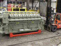 Here is a new 16 cylinder General Electric FDL engine. It puts out 4400 horsepower from it's turbocharged engine. Compare it's size to that of the heavy duty forklift to it's right.