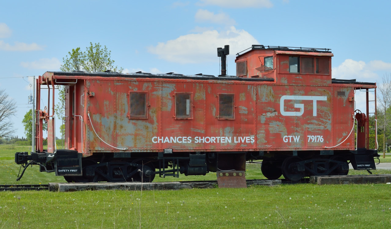 Former Grand Trunk Western caboose 79176 rests next to the former St. Mary's Junction station along the GEXR Guelph Sub.  The Guelph Sub, originally the Brampton Sub, ended at Stratford.  West of Stratford it was the Thorndale Sub which continued to London.  From St. Mary's Junction the Forest Sub ran west to Sarnia.  The 1858 limestone depot is just out of frame at right.