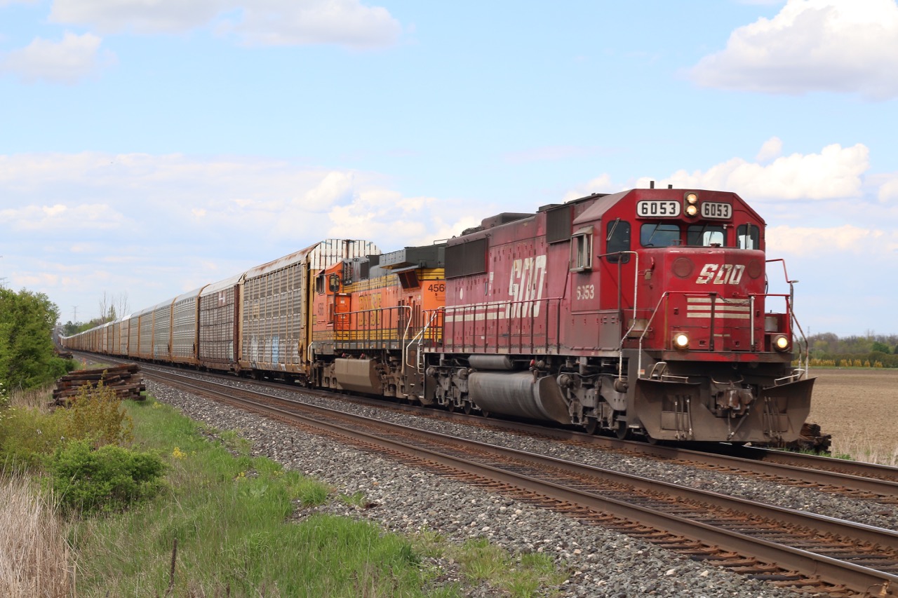 It often seems hard to go out railfanning, these days most trains, especially on CP are dominated by a sea of red 4400hp GE built locomotives. Luckily we still get the occasional surprise, and getting a Soo painted SD60 leading these days is a rare treat. This SOO / BNSF combo are in charge of rack train 147 as they storm out of the dip at Hornby under muted sun.