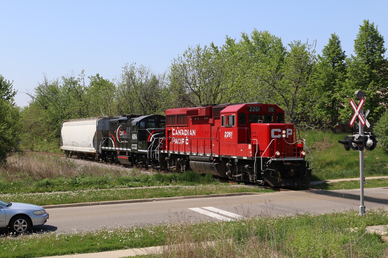 Newly arrived Cando Contracting GP9RM 4014 is along for the ride as it accompanies borrowed CP GP20C 2261 as they head north for Orangeville with one covered hopper in tow. The 4014 will replace out of service 4009 stored at Orangeville.