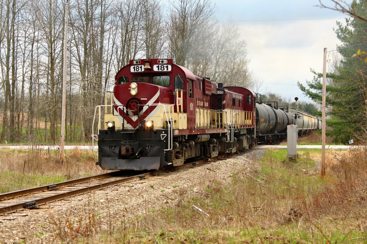Having completed the switching work at Guelph Junction, the pair of older MLW's in GJR 181 and GJR 505, rock and roll along the bolted rails as they power up and cross side road 10 at MM 18.27, on their way back to Guelph. Had this consist been a little shorter, ex CP caboose 434462 would have been visible on the tail end.