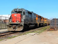 GEXR 3054 leads GEXR 3394 and GEXR 3030 past the Acton Go station and up to MM 35.48 at the Eastern Avenue crossing on their way to Silver. At the right is a very large row of brand new ties with what appears to be  a tie pull cart in the front.