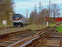 Back to back heritage units on Via 97 and 98, not bad... Here, Via 97 leans into the curve at Clifton with Amtrak 822 in the lead doing a slow and steady 20mph. With traffic not nearly what it once was here it Clifton, CN removed some of the CTC control switches at Clifton in early 2013. Coming from the east, Clifton now converges to single track at the beginning of the junction. The Stamford Sub merges into the single track section, and the Grimsby Sub then promptly returns to double track before Stanley Avenue. CN was able to remove 2 of 6 CTC switches by doing so, which I guess is saving CN money. Nonetheless, those removed switches are now scattered in the foreground of this photo. The relatively obscured third track in the foreground used to run into a lumber yard just beyond the Stanley Avenue crossing, and they seemed to run for the hills when the Great Recession hit. With Niagara Falls Yard gone too, not much is left, except for the manifests and two daily Amtrak trains. Next weekend, and during the summer, GO service will get going though. Since Niagara is outlined in the Ontario budget now for new permanent GO train service, maybe Clifton will be cleaned up a bit and upgraded a bit, as this is one of the junkiest CTC junctions I've seen.