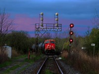 Early dawn begins to hit the nose of CN 2341 as it idles away just short of the Port Robinson West interlocking with CN 422. At the head end, 331's death bed lies in the consist (empty Vinyl Chloride tankers). From past experiences at Port Robinson, including many very early morning trips go out of Port Robinson Yard and almost half way to Thorold Stone Road was quite common. I never bothered to stay out past 6am though as yard operations died until around 9am when Port Robinson became a barrage of granny drivers that like to drive 20 below the limit. I've even been screamed at multiple times to slow down in the downtown area while driving the speed limit (both were people standing almost in the middle of the road). As of very recently though, CN 422 has left Port Robinson shortly after 0600 on several occasions, where as before a 0900 departure was the earliest you'd see. This new scheduled time or whatever it may be is good for me as I don't have to deal with the slow knuckleheads in the area who frequently tap their brakes for invisible cars, or the crazy locals standing in the middle of the road screaming at me. However, another advantage appears to be the lighting, which was quite mellow yet not the drabby overcast kind of mellow. The sky made short work of that as it was completely overcast only a few minutes later. <br><br>422 would throttle up about a half hour after I left. As it had consistently been so recently, 422 was about 11000 feet, however dozens of 89 foot autoracks, 89 foot flat cars and 86 autoparts cars meant only 140 cars were needed to make up that length.<br><br>As for this particular interlocking, like many others on the Stamford Sub, it is a wye which leads to other subdivisions. The track to the right goes to the CN Thorold Spur. This wye is mostly utilized at night it seems. Oh, and the Geep yard power that used to be at Port Rob, I haven't seen them in months. All the six axle units have been doing all the switch grinding work it seems. The rails in the foreground show relatively clear signs of what appears to be wheel slip. Well, considering this is a takeoff point for 150 car behemoths, I guess that's not a surprise.