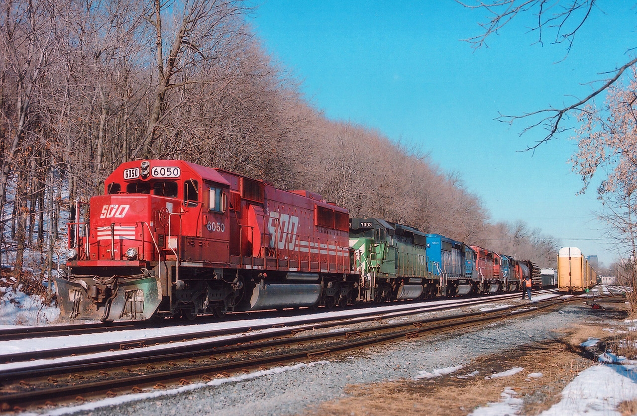 Those of you that have taken up capturing trains in their environment in the past couple of years are probably disappointed that views such as this one are only 5 years old.  How times have changed. We have gone from colourful lashups such as this #246 to today's mostly pairs of grimy GEs that look like they were painted at a child's art class. Sitting at Kinnear, and about ready to depart southward/eastward is SOO 6050, HLCX 7003, CEFX 3163, CP 5958 and HLCX 7193. Incidentally, this is the first image I have offered that was shot using a Mamiya RB67. Great quality for a film camera. I'm using Fuji 400 ISO 120 roll film. Ten frames to a roll. Also, one of the reasons we are seeing the same old, same old as power over CP is due to the downturn in traffic (as in oil) and the effects of EHH, over 665 locomotives are currently stored around the CP system.