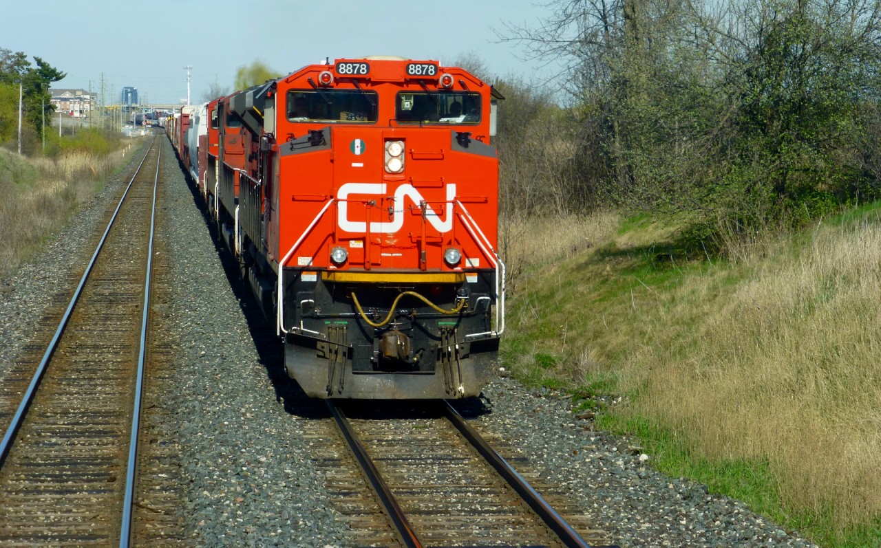 A very clean CN SD70M-2 8878 is in charge of this very large M399 as it passes through Norval,Ont on a warm sunny afternoon. CN 523 passes 399 after setting out 9,424ft of traffic at Aldershot.

With the demise of CN trains 330/331, some trains are now much larger and will be operating with DP power as required. May 7/16 both 421 and 385 were DP powered trains. 421 was almost 16,000 tons and over 11,000ft out of Mac Yard.