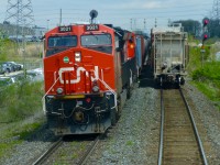  CN train 435 departs Mac Yrd at Snider West lead by CN ET44AC 3021 as the last car of an 11,000ft 422 is clearing the inbound track of the Halton Sub.