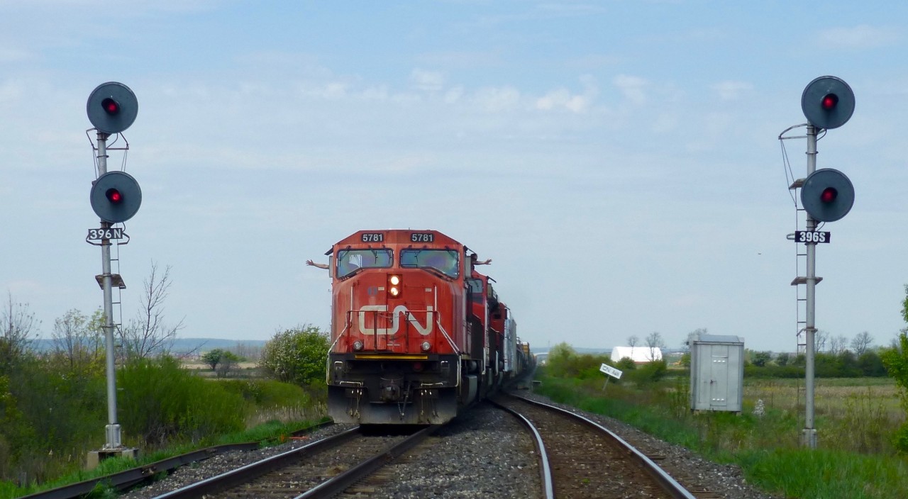CN 523's crew gives a big wave to the test train crew doing an inspection at Ash on CN's Halton Sub. Since the demise 330/331 from Sarnia to Pt. Robinson there seems to be a big increase in traffic between Pt Rob and Mac Yrd. 523 ran 4 days in a row from Mac Yrd to Aldershot and back  and there have been 524's from Pt Rob to either Aldershot or as in todays case, right to Mac Yrd. This is addition to the regular 421/422 trains.