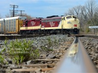 With 50 cars in tow, OSR has to make two cuts to bring their cars into Woodstock yard, in this photo OSR is bringing their second cut across Carew diamond while their flagship FP9A is reflected in the shiny rails of the CNR Dundas subdivision. Despite the rapidly clouding weather I got lucky with the sun on this trip!

