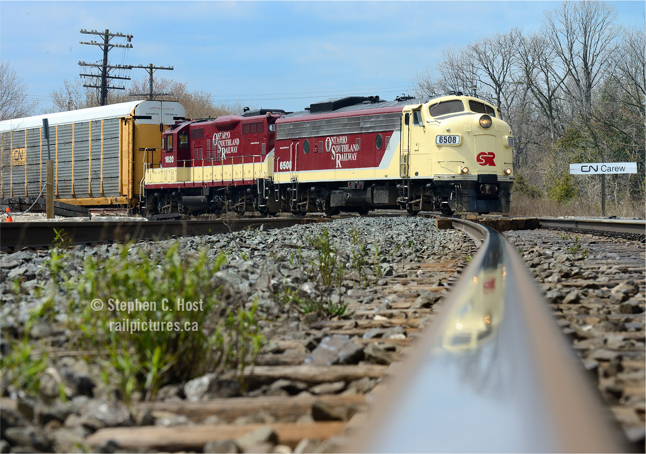 With 50 cars in tow, OSR has to make two cuts to bring their cars into Woodstock yard, in this photo OSR is bringing their second cut across Carew diamond while their flagship FP9A is reflected in the shiny rails of the CNR Dundas subdivision. Despite the rapidly clouding weather I got lucky with the sun on this trip!