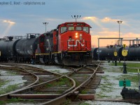 With orange beams of late evening light peeking through holes in the cloud, a CN yard job from Sarnia is switching three cars in (and zero out) of Procor's Sarnia facility.
