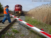 <b>Railway crossing?</b> During my OSR trip on April 30th (see my four previous photos) I took a detour to Zorra to shoot T69 who I heard switching the former St. Marys sub over the radio. While there, a farmer towing his tractor in a pickup truck ripped the gate off at Zorra, so the pictured Conductor had to move it to the side for the approaching westbound as well as for itself. The gate was simply off its hinge, and still flashing while lying on the track.<br><br>
A rule 103 was quickly put in place and unfortunately for the crew and the RTC, I did not get the license plate of the offending farmer despite photographing the ordeal and a signal maintainer would have to come out to fix the crossing.