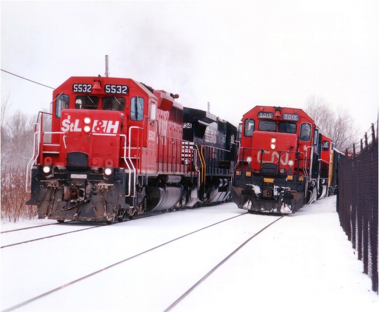 I was walking the area for a different sort of photo when CN came by. The CN 5015 (with 5720 trailing) was a treat as I liked those old SD40s and the fact they were getting tired meant they might not be around much longer. (All were off the roster by 2006) Then along came the daily #328, and here I am in a perfect position for a good shot. Tight, but good. This image is taken from out back of the Glendale GM plant, just east of the canal, no longer accessible to foamers, I believe, unless there are some "secret" pathways I have not yet heard about........... The #328 looked smart with STLH 5532 leading NS 8734 and CP 5536. And just enough snow.