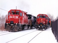 I was walking the area for a different sort of photo when CN came by. The CN 5015 (with 5720 trailing) was a treat as I liked those old SD40s and the fact they were getting tired meant they might not be around much longer. (All were off the roster by 2006) Then along came the daily #328, and here I am in a perfect position for a good shot. Tight, but good. This image is taken from out back of the Glendale GM plant, just east of the canal, no longer accessible to foamers, I believe, unless there are some "secret" pathways I have not yet heard about........... The #328 looked smart with STLH 5532 leading NS 8734 and CP 5536. And just enough snow. 
