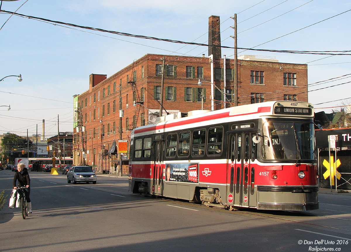 Dodging shadows with cars and cyclists, TTC CLRV 4157 heads south on Bathurst Street at Wellington on a 511 run, after diverting back onto Bathurst at Adelaide due to road construction between Dundas and Richmond.