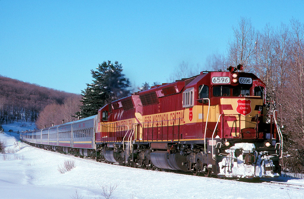Train 3 the ASNOW heads north with WC 6596 and 7551 leading 13 cars near Bellevue ONT.  The FP9's started to have trouble keeping up with passenger duties in the late 90's and numerous freight units started to fill in some cases.