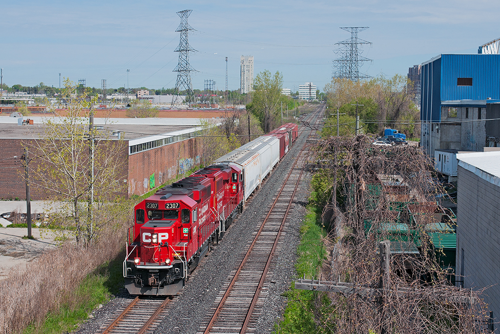 An extra yard assignment out of Agincourt trundles down the former Canadian Pacific Canpa Sub, now owned by Metrolinx (GO Transit). Behind the pair of GP20C-ECO's is three plastic cars for one or maybe two customers, Polytainers at Area H or Hymopak at Area I and five clay hoppers for Versapet. Versapet used to be serviced by CN Rail not that long ago on the Uxbridge Sub but moved to a bigger facility along the Canpa after being told off by management about wanting regular service. Talk about customer service, eh ?
