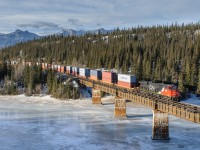 Prince George based CN ES44AC 2963 leads Q196's train out of The Rockies and over the Athabasca River between Entrance and Solomon on CN's Edson Sub.