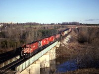 A common practice in the day of 500 series trains was dead heading power and vans westward as seen on today's 507 . CP 4560 4735 4561 providing the power and idling 5406 4202 5403, along with two vans on the head end.