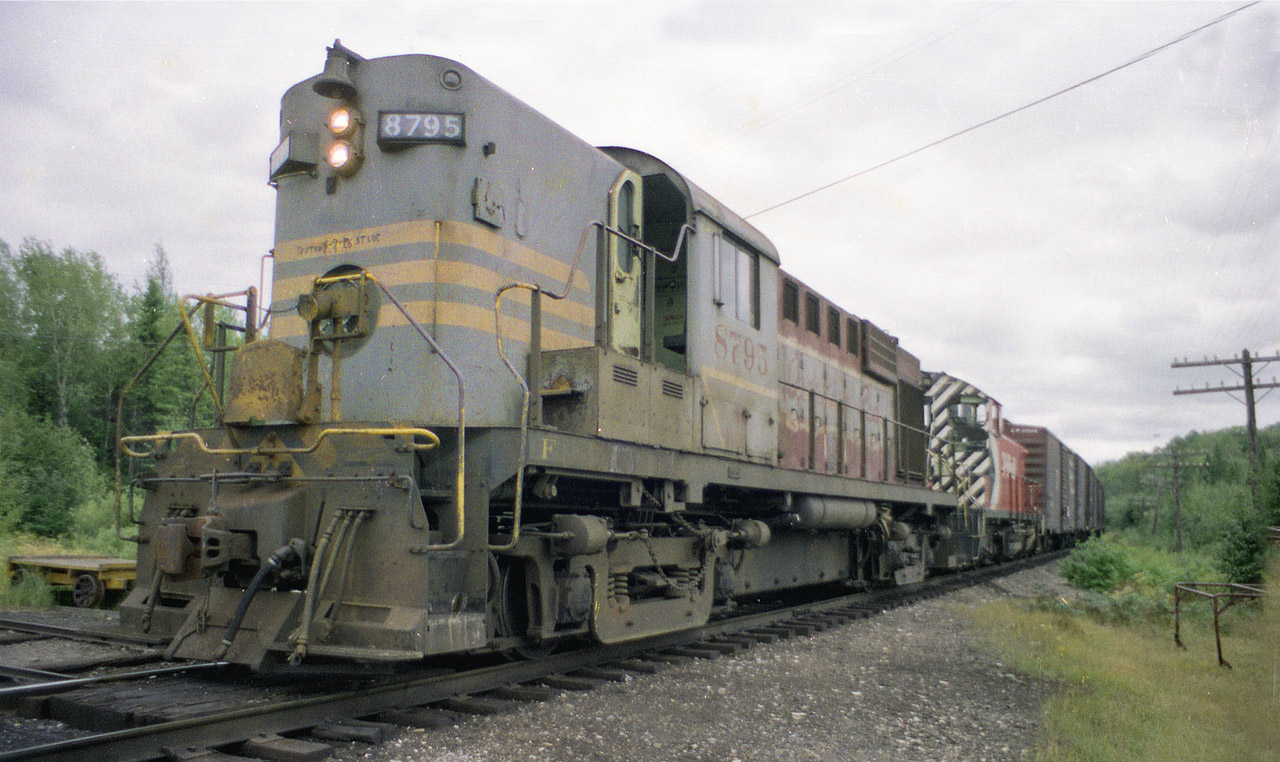 As of this posting we are a couple of months off 40 years since this photo was taken. It is 35mm negative film, so the quality has gone south, somewhat. It has even been 19 years since Huron Central took over this trackage from CP.  In this image, CP 8795 and 8153 have just returned to McKerrow from Espanola and working the big pulp & paper co there; Eddy Matches was once a big employer in Espanola...... The train is rounding the wye at McKerrow and heading east to Sudbury.  RS-18 CP 8795 became part of the rebuild program in the 1980s; becoming RS-18u 1833; all the 1800s off the roster by 1998. The 8153, an SW1200RS, was dealt to Rail Trusts Equipment in 2003. I cannot quite make out the markings below the headlights on 8795, but it appears to be "tested (with date)St. Luc", and in smaller print below the first it does read 4-3-71.