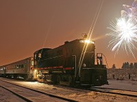 Judy's take of the Guelph Junction Express 2009/2010 New Year's Special with fireworks at Arkell. The combination of a slightly more head-on shot and a kit lens produced increased flare - normally not particularly desirable - but in this case I thought it added to the dramatic effects provided by the fireworks.