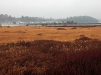On a rainy, misty and typically miserable November day in 2010 the Northlander is running about 45 minutes late as it approaches the south switch at Martins, crossing the causeway that separates the southern tip of Siding Lake from its main body. 