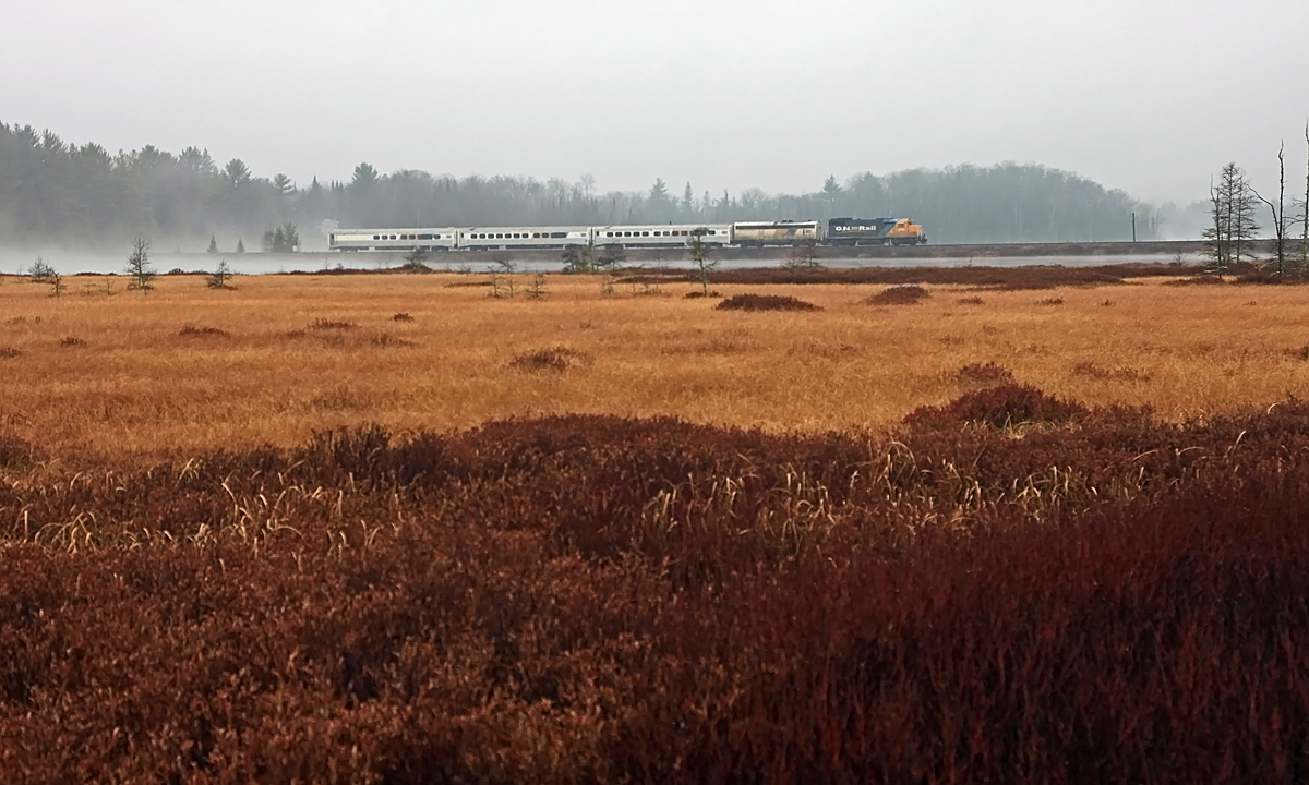 On a rainy, misty and typically miserable November day in 2010 the Northlander is running about 45 minutes late as it approaches the south switch at Martins, crossing the causeway that separates the southern tip of Siding Lake from its main body.