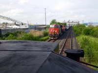 CN 383 has just left Mac Yard and crossed the Humber River on its way to Sarnia, Ont. Lead by ES44AC 2808 an unknown sister trailing and ET44AC 3003 in DP mode mid train.

 CN L570 waits for 383's tail end to clear Humber. The "WisperCab" split on CN SD70-2M  8964 can be seen through the window on this shot. 