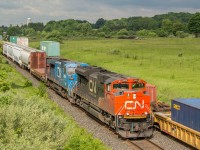 During a small break in the clouds, some morning light bears down on 376 as it passes CN 107 through Newtonville.

107 has a a pair of ACes for power - 8102 & 8101

376 - 8964, IC 2456 & DP 8000

