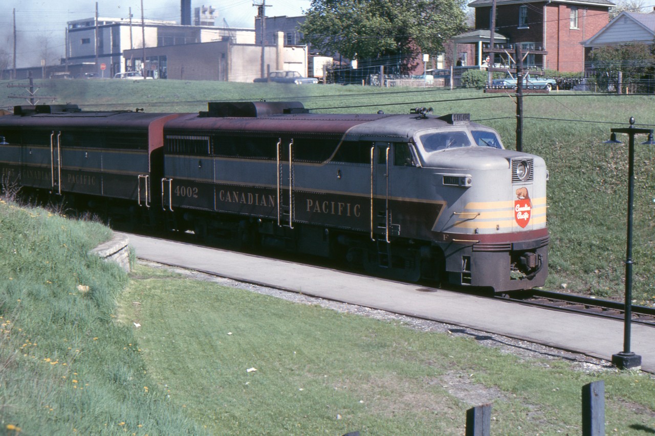 FA-1 4002 leads 903's train and has just passed under Simcoe Street, Oshawa in May 1965. The Oshawa Dairy plant can be seen in the top of the photo. It was taken over by one of the big milk companies and torn down a few years later.