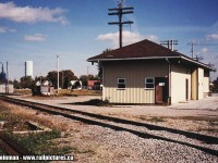 The Canada Southern was once a mighty railroad, hauling freight and passengers from Detroit to Buffalo. They used Southern Ontario as their 'shortcut', and brought a new competition to what eventually was the Canadian National and the Canadian Pacific Railways. 
<br>
However, as evidenced by the shot I took in 2003, all rail of the once mighty Canada Southern had been pulled out. All that is left are memories...note the concrete base at the left hand side. This was the CS control tower for the diamond crossing of the CN Hagersville Subdivision. Also, the station still exists in Hagersville despite being clad in ugly yellow siding, and is used by crews of what is now known today as the Southern Ontario Railway. The diamond was recently removed, just prior to this shot. In the background, where the boxcar and a shed stand abutted against it, is where the CN's station once stood. 
<br>
Rail still existed between Windsor and St. Thomas until (around) 2012. That's when the last portion of this US railroad - originally built by the Michigan Central, was removed. 