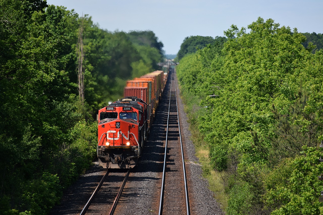 CN 148 approaches Denfield Bridge at mile 5.8, with a repainted IC Deathstar trailing third.