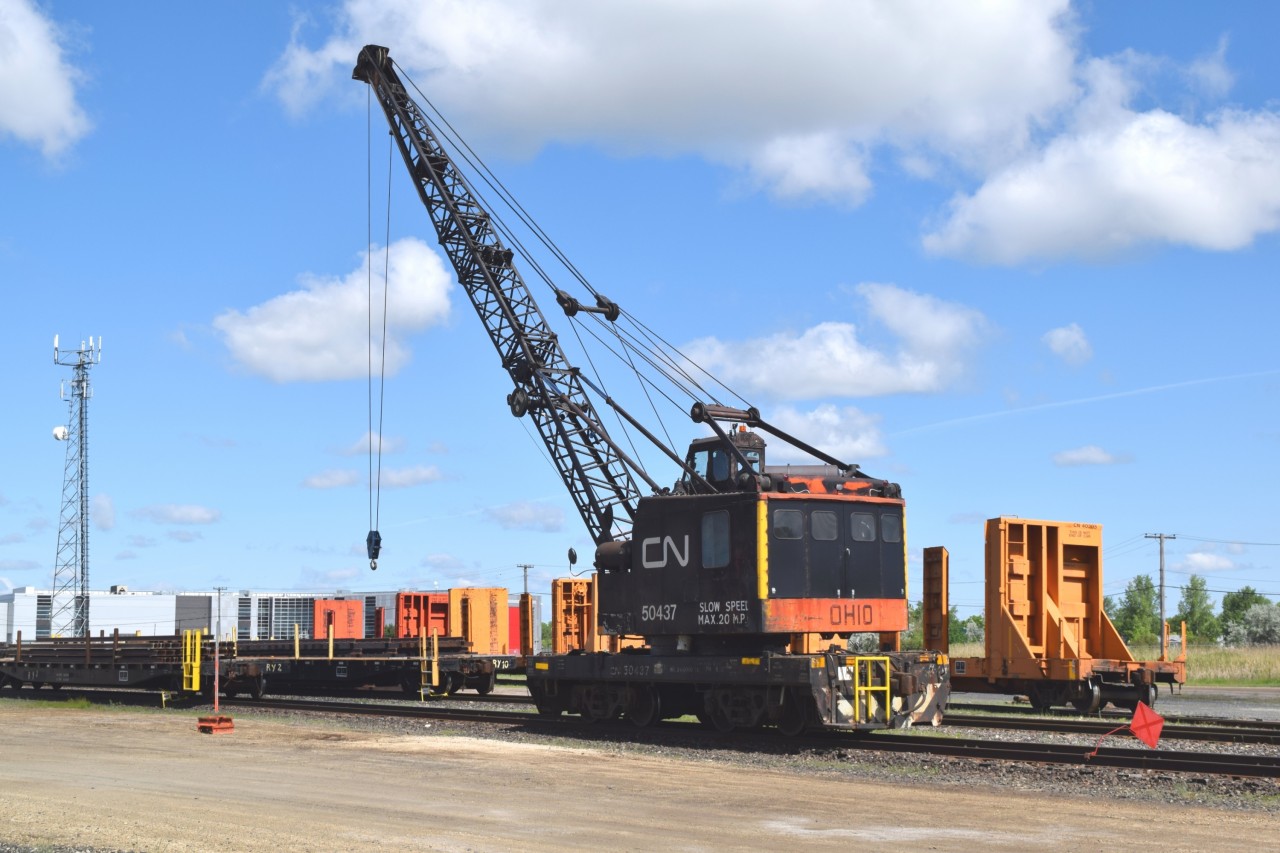 CN 50437, an Ohio DE 400 locomotive crane, moves in to grab RY 2 and a load of new rail for the track panel construction crew at CN's Transcona Engineering Yard. New ties, new rail and new track jewelry make up the track panels that are then loaded on to purpose built cars and sent to strategic locations across CN's system to be in position for derailment response.