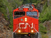 Canadian National ES44AC 2916 blasts through the rock cut at CN conductor Mike Thomas's "Secret Spot," north of McGuire siding on the former BC Rail's Squamish Sub.
