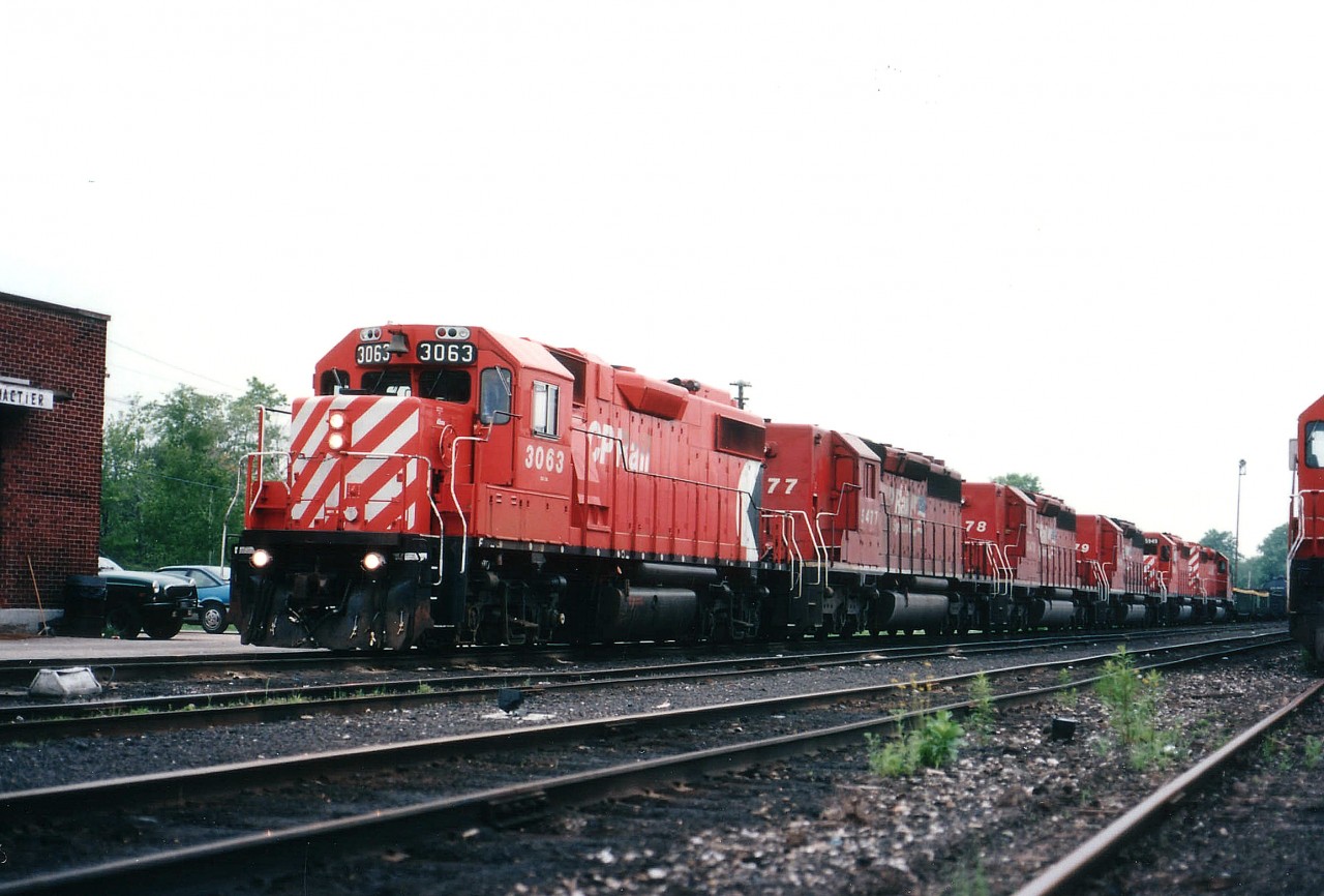 Stopped at CP's MacTier station on crew change, a GP38-2 leads 5 SD40-2s southward. Units are 3063, 5477, 5478, 5479, 5949 and 5999. Of interest are the three in numerical order; part of a series demoted to "B" status, cabs stripped and windows painted out. The first two retired in 2005 and went to Progressive Rail, the 5479 retired in 2003 and went to Brazil in 2007. The last two presumably stored now, or in line for dismantling in CP's ECO program,(they are still on the roster in the 2016 CTG) leaving the leader as the last unit to soldier on.