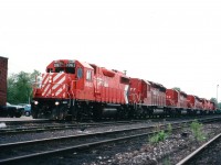 Stopped at CP's MacTier station on crew change, a GP38-2 leads 5 SD40-2s southward. Units are 3063, 5477, 5478, 5479, 5949 and 5999. Of interest are the three in numerical order; part of a series demoted to "B" status, cabs stripped and windows painted out. The first two retired in 2005 and went to Progressive Rail, the 5479 retired in 2003 and went to Brazil in 2007. The last two presumably stored now, or in line for dismantling in CP's ECO program,(they are still on the roster in the 2016 CTG) leaving the leader as the last unit to soldier on. 