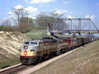 Canadian Pacific FA2 4051 passes under London's Sarnia Road bridge in May of 1964, leading a freight with an RS10 and FB1 trailing under the tell-tales. The Sarnia Road bridge was a single lane  structure that had sharp turns leading up to it, and was major bottle neck. It was built in the 1880s crossing CP's Windsor Sub at Mile 3.0 in the west end of London, and was replaced by a modern concrete bridge in 2011.