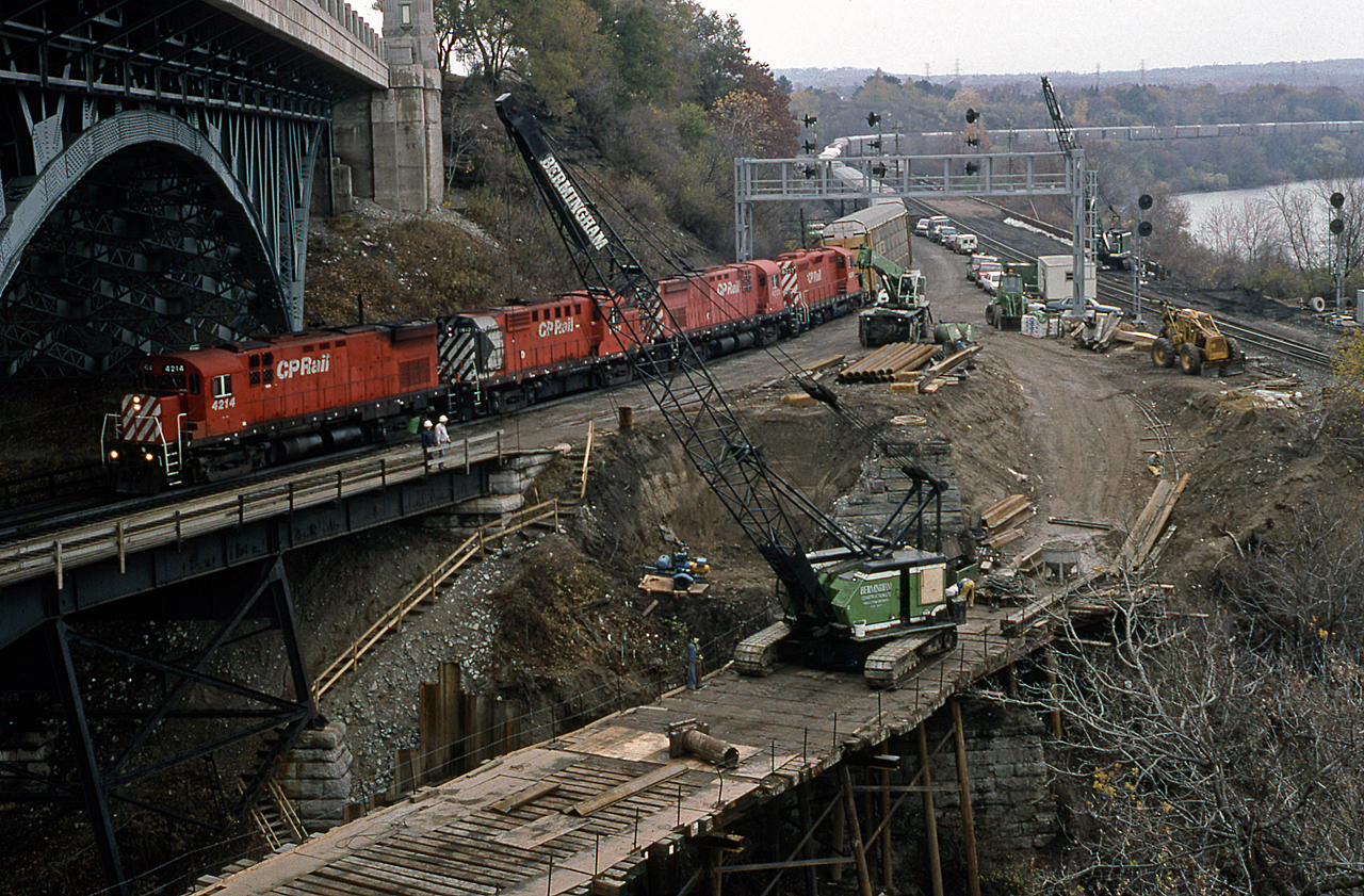 Time machine: remember back in 1994 when GO Transit was pushing to reach the second Hamilton commuter station? Revival of the old Hunter Street TH&B station spelled the end of GO train service to the former CN James Street station, at least for a while. It also meant changes at Hamilton Jct, the union of the Cowpath, the CP, and the CN Oakville Sub in the form of a new connection. Despite a connection already in place between CN and CP, it was decided to build, on taxpayer money, a new bridge specifically for the expanded GO service to Hunter Street. Then, as now, Bermingham had the contract to the preparatory work for the new bridge. Fast forward almost 22 years, and the next GO Transit expansion in Hamilton has seen the construction of the West Harbour station on the site of the old James Street station (in fact, almost underneath it). This again means changes at Hamilton Jct, with a new track to be placed on the west side of the CN Main and Connecting tracks. 

Meanwhile, CP 526 is somewhat a relic of the past, exercising trackage rights on the CN Oakville sub between Hamilton Jct and Canpa. On this day, we find CP 4214, 1812, 4233, and 8237 hauling autoracks towards the Steel City. CP 4214 would go onto serve QGRY and NBEC under the same number, until CN takeover of the latter resulted in the unit meeting the torch in 2010. Stay tuned for a present-day update. Reg Button photo, author's collection.