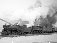 A westbound Canadian Pacific freight passes through Cooksville, just about to pass under the Highway 5 (Dundas Street East) overpass east of the station on October 19th 1959 at 4:30pm. P2g-class Mikado 5405 is in charge of the train, assisted by G1 2228 coupled on the front.
