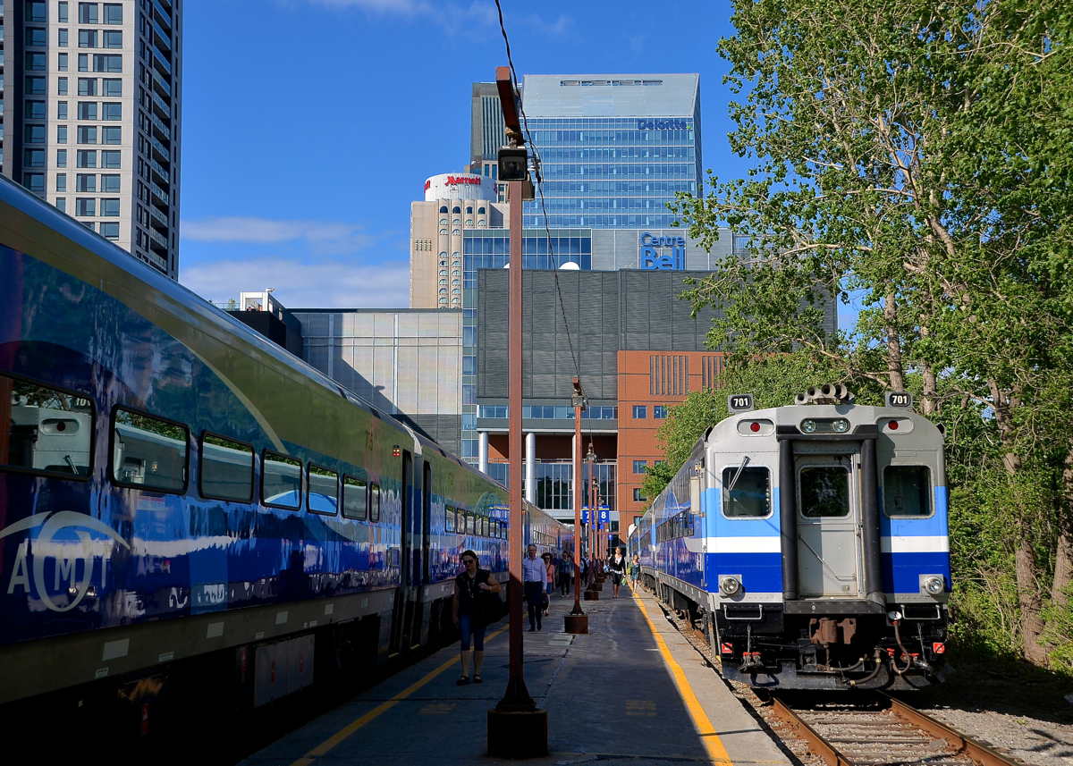 The evening rush hour. Two Candiac-line trains are at Lucien L'Allier station in downtown Montreal during the evening rush hour. Behind is the Bell Centre and the new Deloitte tower.