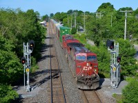 <b>Splitting the signals.</b> CP 118 splits the signals just east of Cedar Park station as it heads through Pointe-Claire with CP 9701 leading on a gorgeous morning.