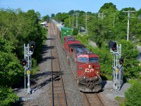 <b>Splitting the signals.</b> CP 118 splits the signals just east of Cedar Park station as it heads through Pointe-Claire with CP 9701 leading on a gorgeous morning.