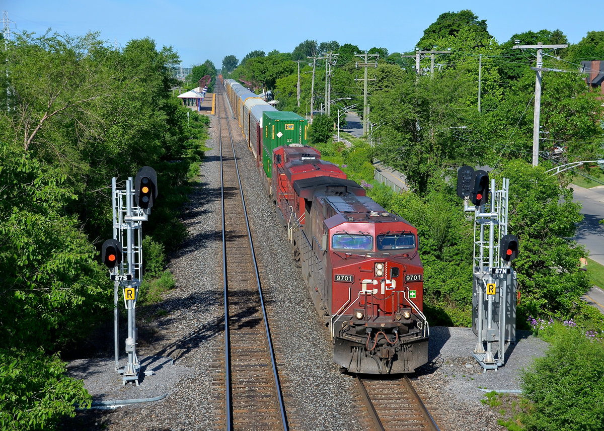 Splitting the signals. CP 118 splits the signals just east of Cedar Park station as it heads through Pointe-Claire with CP 9701 leading on a gorgeous morning.