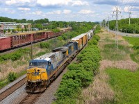 <b>A (somewhat) rare GE model leading.</b> CN 327 is westbound through Pointe-Claire led by big GE product CSXT 631, an AC6000CW. In North America only CSXT and Union Pacific bought these units, and in limited numbers. Trailing is an ex-Seaboard SD50. At left is CP 119 on CP's parallel Vaudreuil sub, its head end had passed just 30 seconds before CN 327's did.