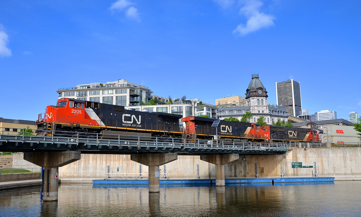 The other side of the bridge. I've shot CN 149 in the Port of Montreal on the other side of this bridge over the Lachine Canal quite often during the past 6 months, but when the days are as long as they are now, the sun swings around enough to be able to shoot the other side of the bridge. Here CN 2205, CN 2244 & 1012 lead CN 149 on the first leg of their voyage towards Toronto and eventually Chicago. Here is a shot from the other side of the bridge.