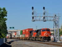 <b>Under the fairly new signal gantry.</b> CN 2943 & CN 3048 lead CN 120 underneath a fairly new signal gantry that was installed at the end of last year when CN moved their right of way through the St-Henri neighbourhood of Montreal. Operating mid-train is CN 2914.