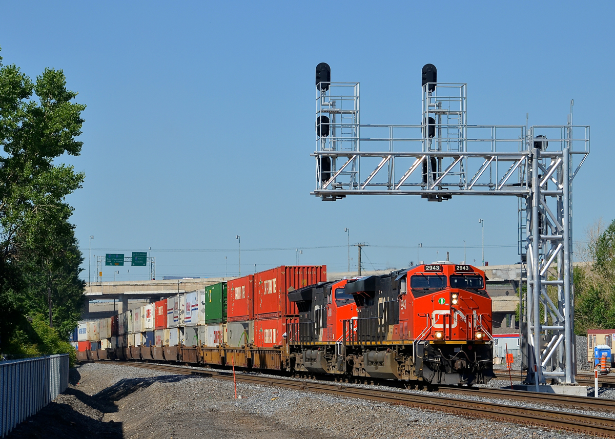 Under the fairly new signal gantry. CN 2943 & CN 3048 lead CN 120 underneath a fairly new signal gantry that was installed at the end of last year when CN moved their right of way through the St-Henri neighbourhood of Montreal. Operating mid-train is CN 2914.