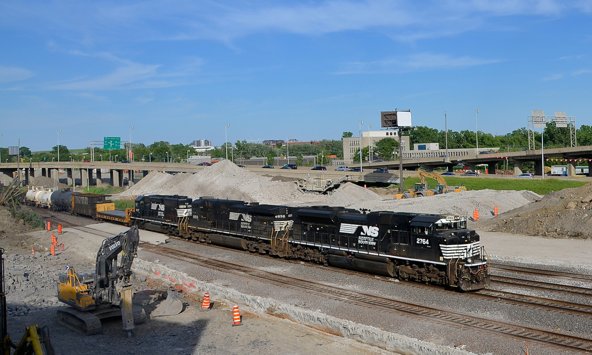 A nice lashup past the demolished tunnel. CN 529 has a nice lashup consisting of SD70M-2 NS 2764, C40-9 NS 8858 & SD40-2 NS 6137 as it passes the ground up remains of the tunnel that used to cover CN's Montreal sub here.